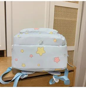 Light blue school backpack detail view featuring cute colorful star patterns and adjustable straps.