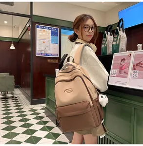 Detail view of a fashionable college style two-tone student backpack in a cafe scene.