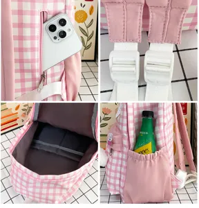 Close-up details of the pink plaid student backpack, showing multi-pocket design and strap.