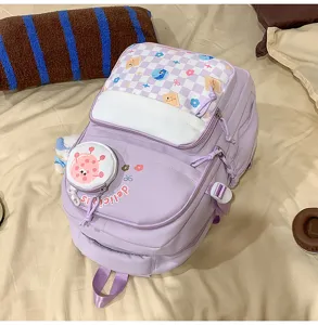 Detailed view of the cute purple backpack with front pocket and checkerboard flap design.