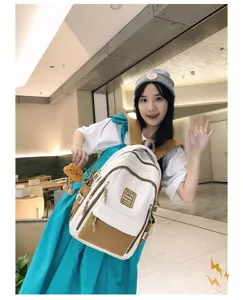 Details of the Japanese color-blocked student backpack with plush cloud charm and large capacity.