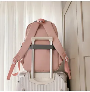 Pink school backpack with luggage strap, lightweight casual daypack for travel and daily use.