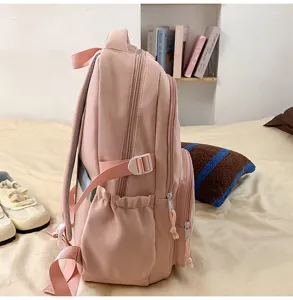 Pink backpack side detail showing multi-pocket design and adjustable strap for daily use.