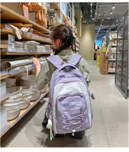 Large capacity purple white contrast color student backpack with cute pendant design detail