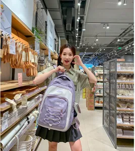 Large capacity color blocking school backpack for students, stylish Korean design casual daypack.