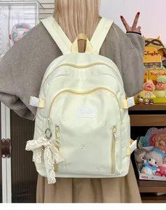 Cute aesthetic yellow backpack with bow embroidery, multi pockets and lace pendant for daily.