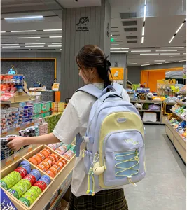 Korean style color-blocking student backpack with large capacity, cute pendant for daily school use.
