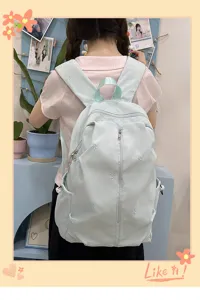 Cute embroidered bow backpack for schoolgirls, casual light blue travel daypack with pockets.