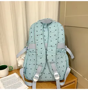 Detail view of cute light blue bow print backpack, lightweight fabric, casual daily school bag.