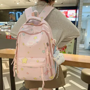 Sweet pink canvas backpack with cute star patterns and plush pendant for daily school use.