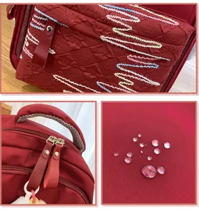 Minimalist large capacity school backpack with waterproof fabric and stylish embroidery details.
