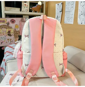 Close-up detail view of the cute Japanese style polka dot backpack with pink bows and straps.