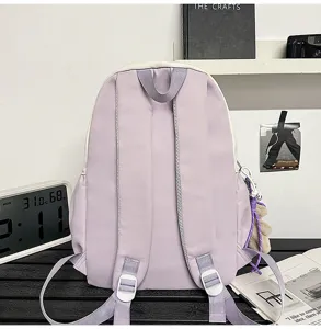 Minimalist purple and white student backpack detail showing straps and smooth fabric.