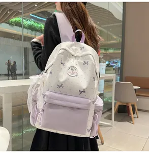 Detailed view of the cute Japanese nylon backpack with bow pattern, showing front pocket and lace.