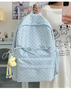 Cute Japanese style polka dot backpack for women, casual light blue school bag with bow and pendant.