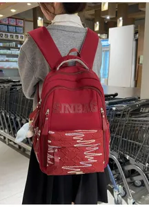 Detail view of the stylish red canvas student backpack showcasing large capacity design.