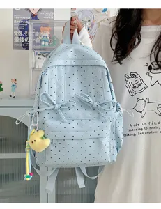 Cute light blue polka dot backpack for women and students with cute bow and pendant.