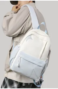 Detail view of the color-block backpack featuring unique star patch design and wide straps.