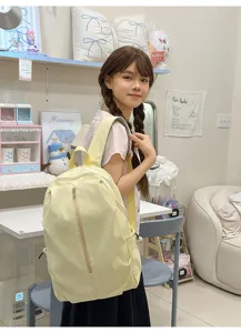 Cute bow embroidered yellow backpack detail showing exquisite stitching and cozy daily style aesthetic.