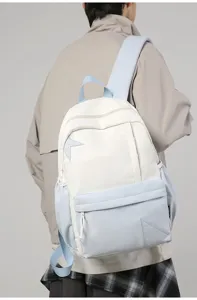 Casual white and blue backpack with stylish star design, large capacity for daily school or travel.