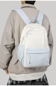 Detail view of a casual contrast-color canvas backpack with stylish star patch and straps.