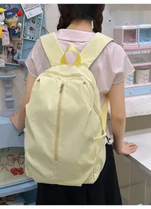 Cute embroidered bow backpack detail, casual daily student school bag in light yellow.