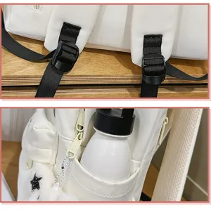 White backpack shoulder strap buckle detail view, durable fabric design close up.