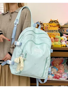 Cute mint green casual backpack for women, large capacity school bag with bow embroidery.