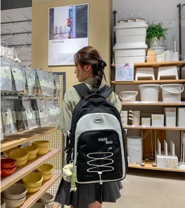 Large capacity black and white color blocking backpack, Korean style student school bag detail.