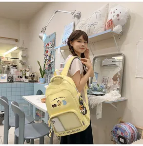 Detailed view of the cute yellow canvas backpack with clear phone pocket and cat embroidery.