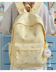 Cute yellow butterfly print school backpack with fluffy keychain for teen girls and college students.