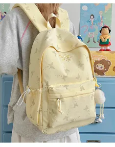 Canvas backpack detail view featuring cute butterfly print and large capacity for daily use.