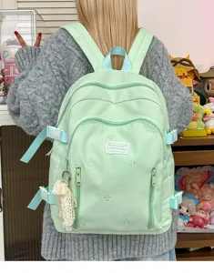 Cute mint green student backpack with multi-pocket compartments and stylish strap details.