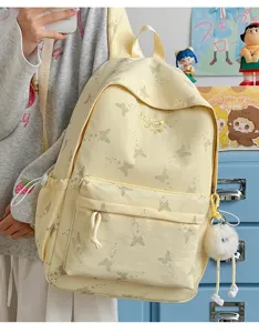 Detail view of the cute yellow student backpack featuring delicate butterfly prints and capacity.