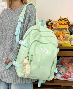 Cute light green school backpack for women, large capacity casual daypack with multiple pockets.