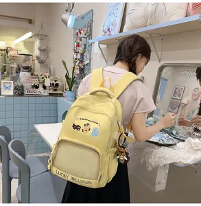 Cute yellow canvas backpack for teenage girls with lovely cat embroidery and large capacity.