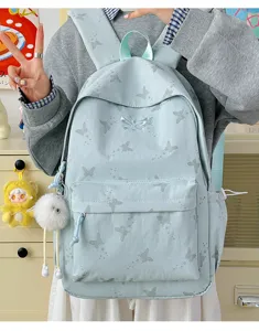 Light blue casual backpack for women, stylish butterfly print school bag with large capacity.