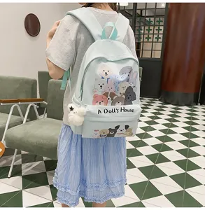 Detail view of cute light blue canvas school backpack with adorable dog graphics and toy pendant.
