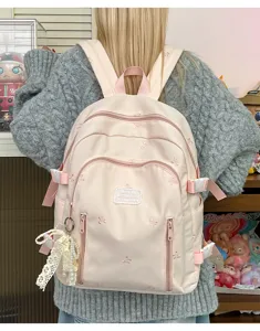Pink cute bow embroidered canvas backpack detail showing straps, front pocket and pearl lace charm.