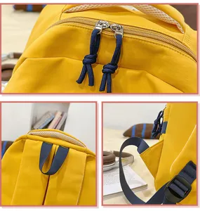 Yellow backpack close-up detail showcasing durable zippers, top handle and adjustable straps.