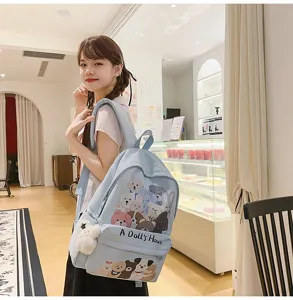 Detail shot of the cute blue canvas backpack featuring adorable animal illustrations and pockets.