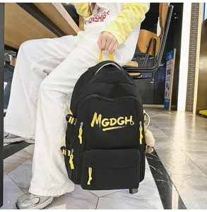 Detail shot showing the black backpack with yellow lettering and adjustable straps in use.