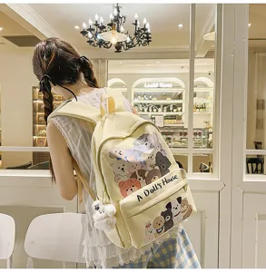 Cute cartoon graffiti canvas backpack with plush puppy pendant for daily school use.