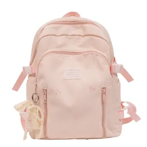 Cute pink school backpack for women and girls, large capacity casual daypack with bows.