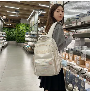 Minimalist solid color large capacity backpack detail shot, lightweight school bag for students.