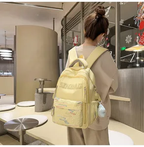 Casual large capacity yellow school backpack, lightweight daily backpack with cute pendant.