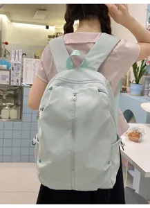 Cute bow embroidered canvas backpack for school girls, casual lightweight daypack travel bag.