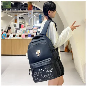 Details of the casual black school backpack featuring cute bear prints and metal bear charm in bookstore.