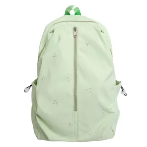 Cute green backpack with bow embroidery for women and students. Casual stylish daypack daily use.
