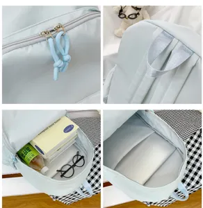 Light blue backpack detail showing zipper pull, durable straps and spacious interior layout.